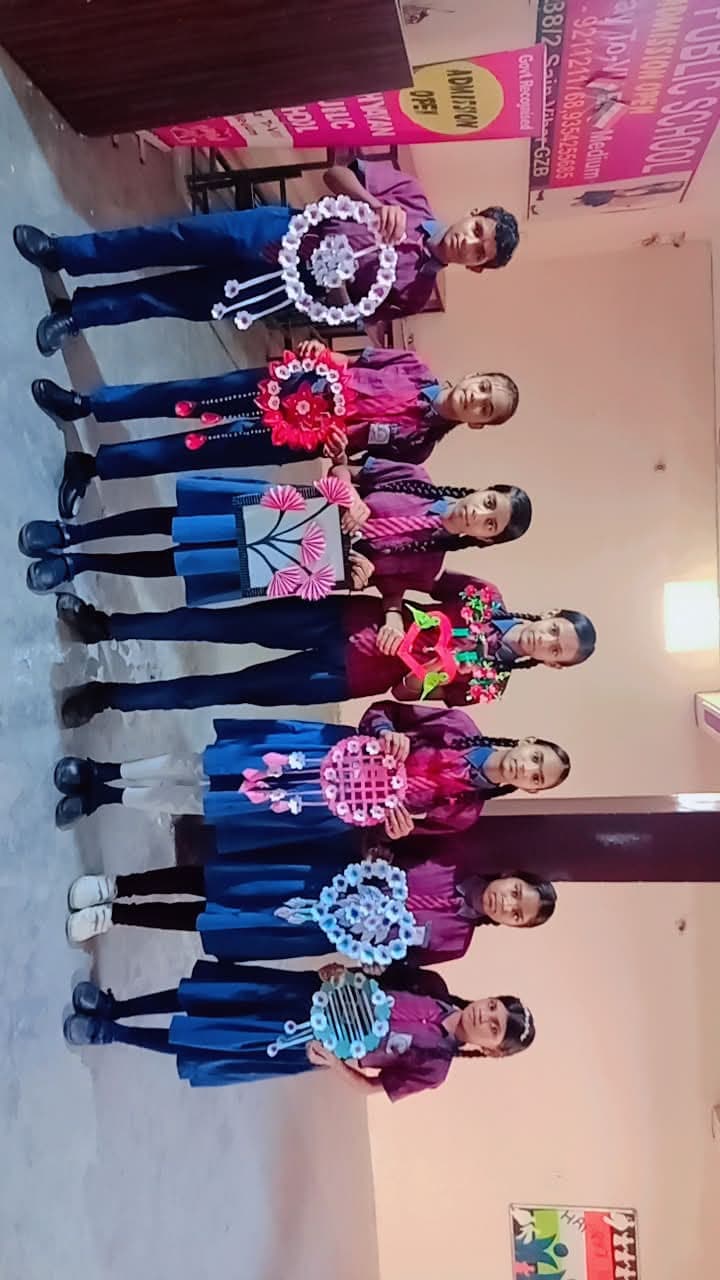 Students holding handmade craft decorations at a school exhibition