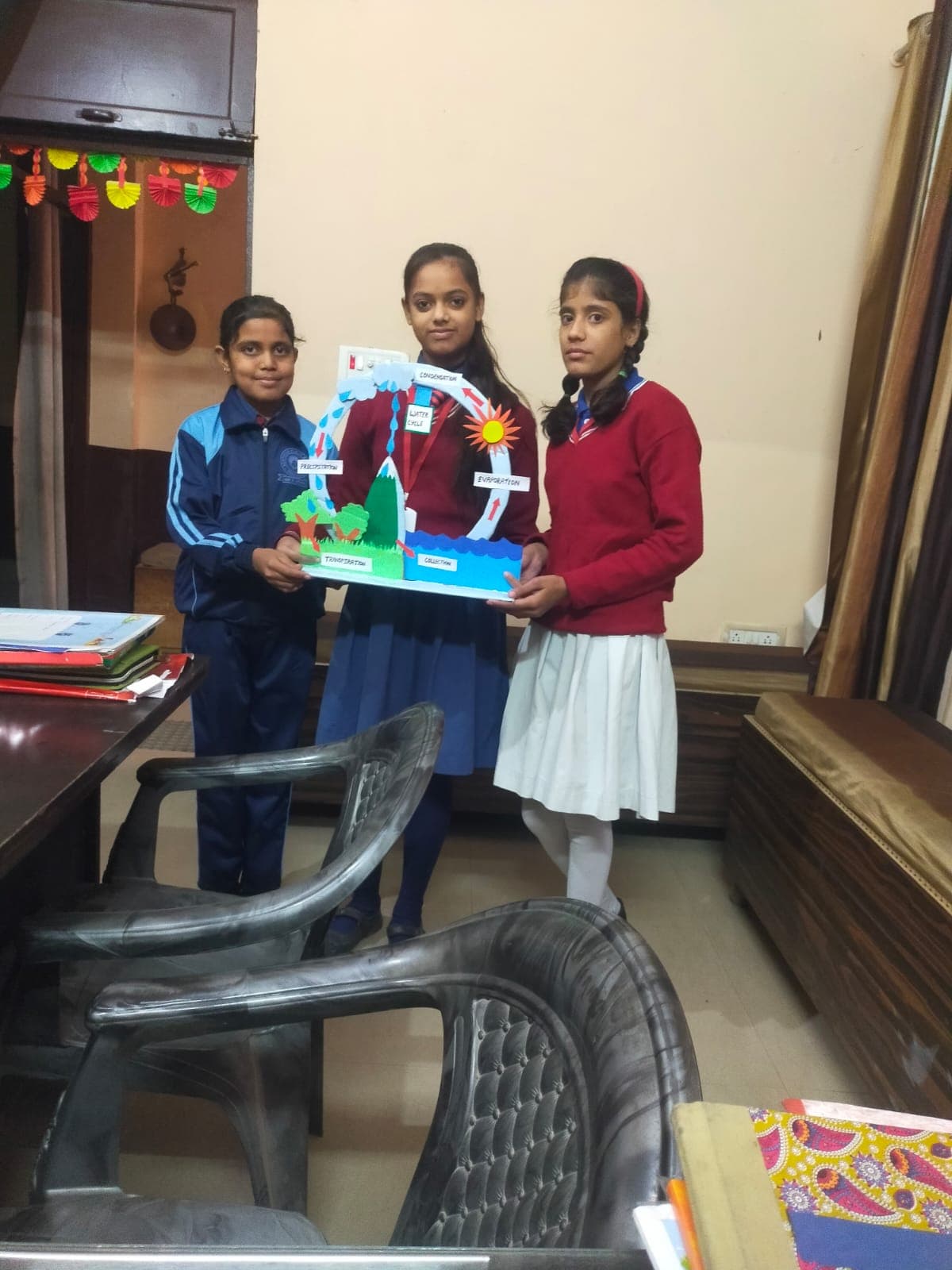 Students presenting a hand-made water cycle science model